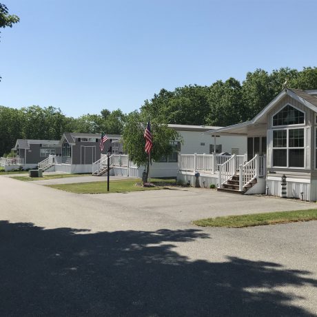 View of a well landscaped neighborhood with American flags at Seacoast Resort