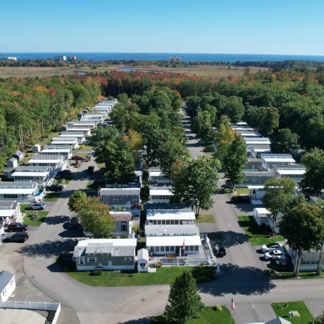 Aerial view of Seacoast Resort and surrounding trees with ocean in the back