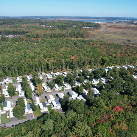 Aerial view of Seacoast Resort and surrounding trees, creeks, ocean and fields