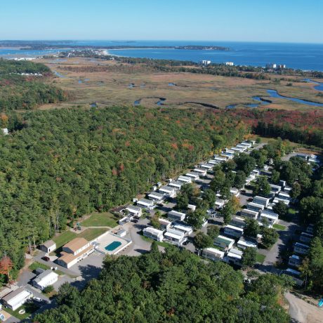 Aerial view of Seacoast Resort and surrounding trees, creeks, ocean and fields
