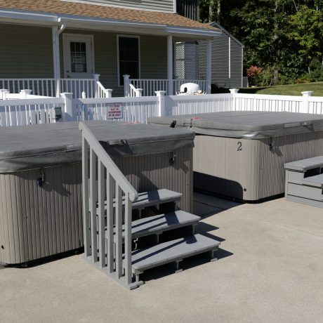 two jacuzzies next to each other with stairs